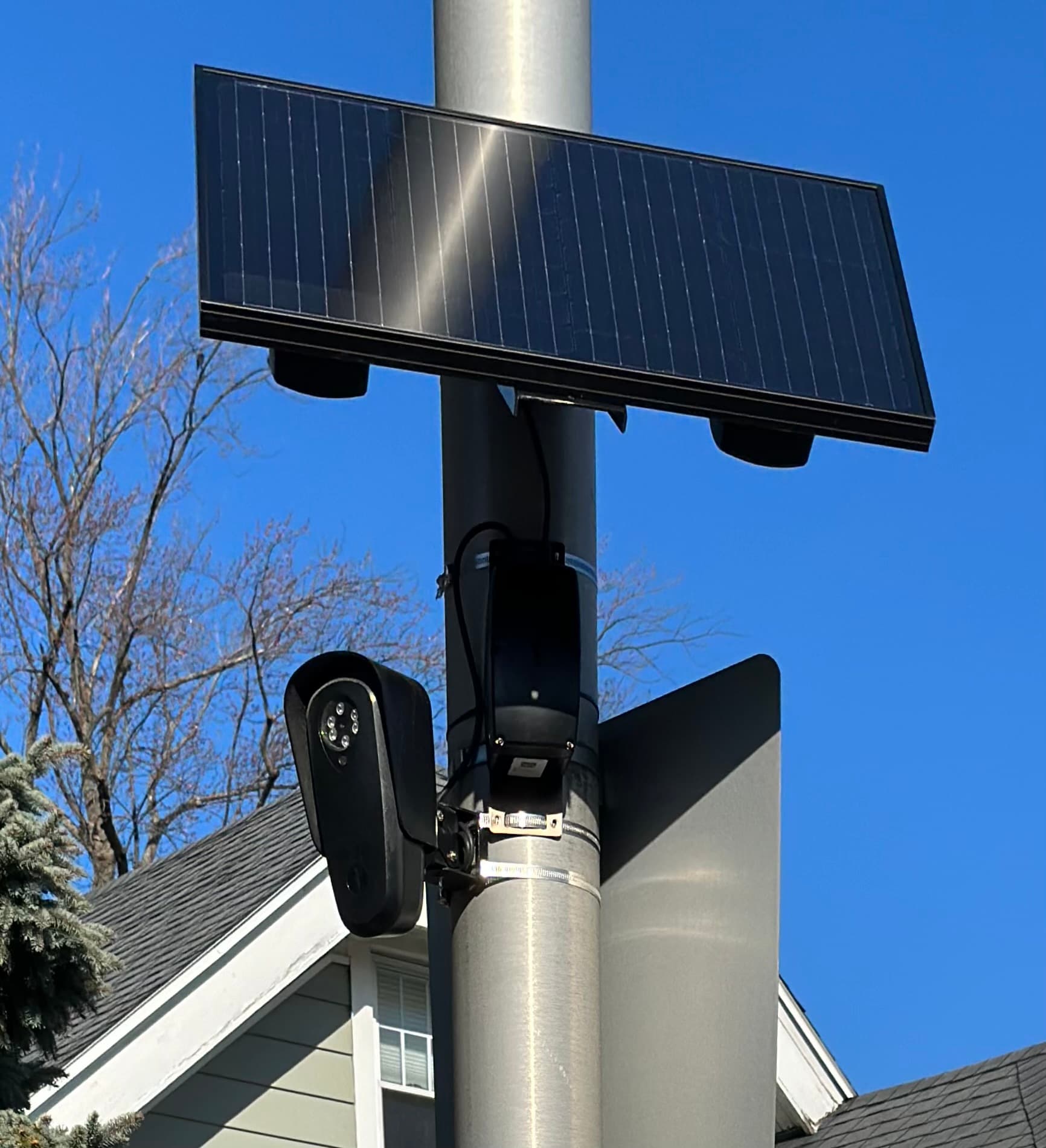 Documented Flock Safety roadside camera mounted below a rectangular solar panel